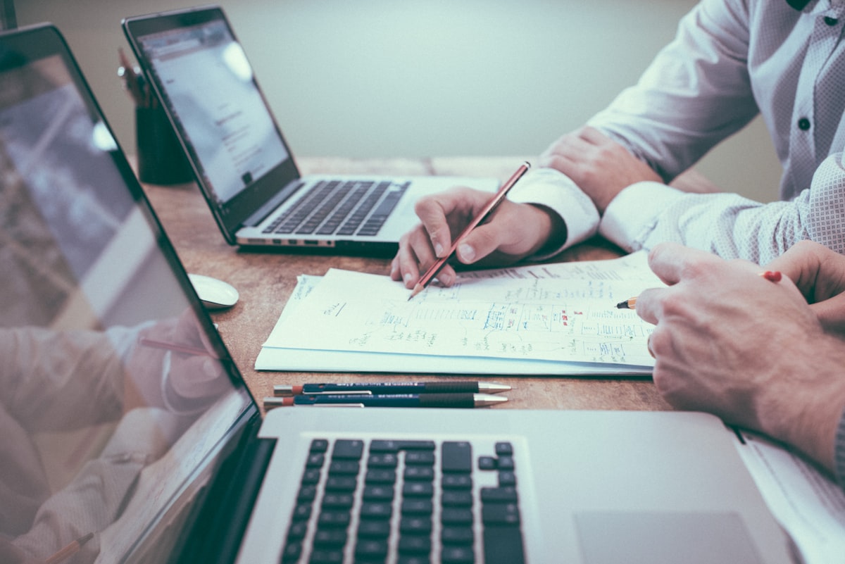 Two people reviewing finance paperwork at a desk